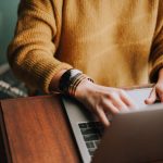 A person typing on a laptop